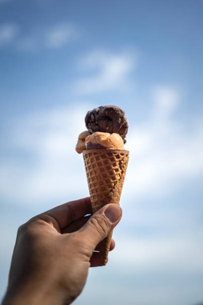 istock Chocolate ice cream scoop in waffle cone. 1405985293