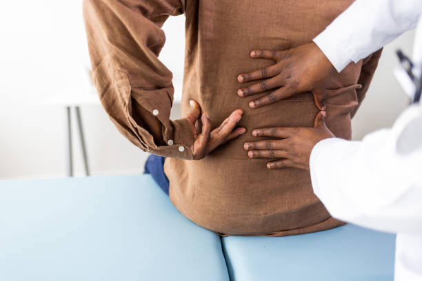 istock Physiotherapist or a chiropractor examining patients back 1405986139