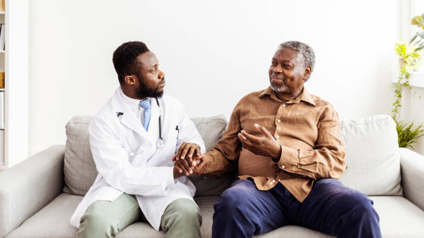 istock Friendly general practitioner communicating with pleasant 80s male patient 1405986159