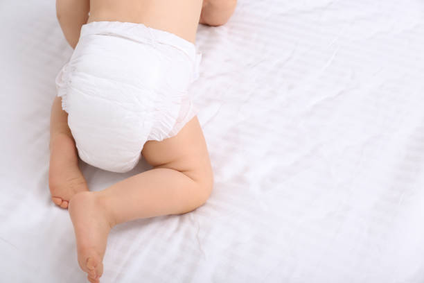 Back view of cute baby in dry soft diaper on white bed, closeup. Space for text Back view of cute baby in dry soft diaper on white bed, closeup. Space for text ass boy stock pictures, royalty-free photos & images