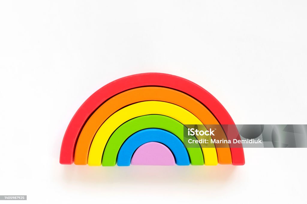 Wooden rainbow isolated on a white background. The rainbow toy puzzle. LGBT flag gay pride community, equal rights movement and gender equality life concept. Flat lay, top view, copy space Wooden rainbow isolated on a white background. The rainbow toy puzzle. LGBT flag gay pride community, equal rights movement and gender equality life concept. Flat lay, top view, copy space. Banner with place for text. Studio shot. Happy pride month. Anniversary Stock Photo