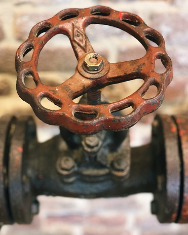 Old rusted valve in an abandoned factory