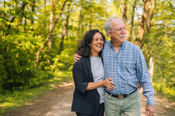 istock Mixed Heterosexual Couple Walking in the Nature Reserve  While Talking 1405988264