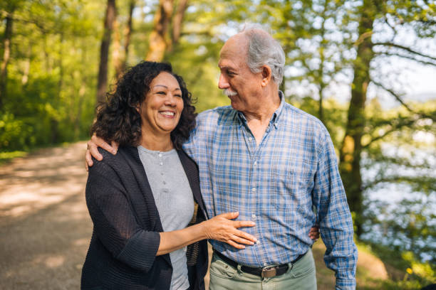 istock Retired Mixed Couple Walking in the Town Park  While Having Fun 1405988270
