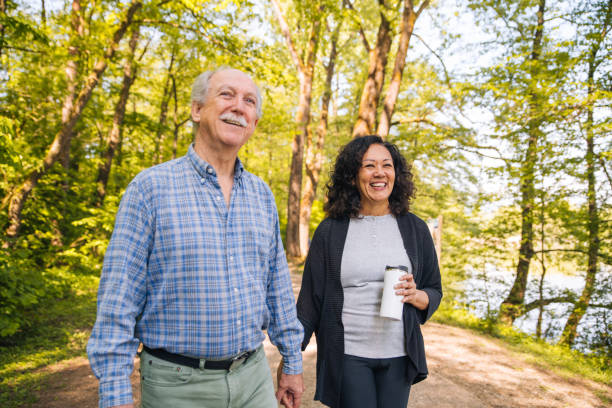 istock Romantic Old Mixed Couple taking a Walk Through the Woods 1405988277