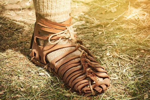 An ancient Roman man legs in caligae leather sandals. Reconstruction of the events of the Roman Empire