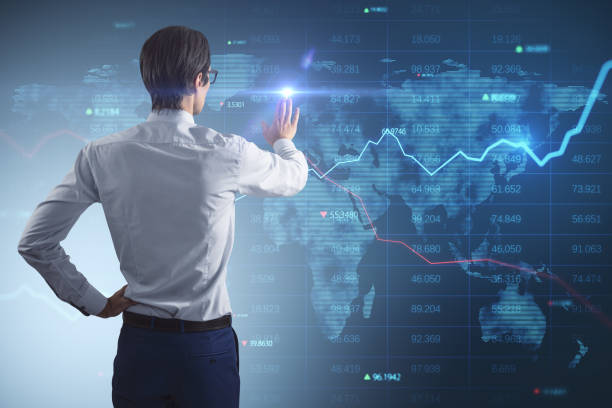 istock Investing, analyzing and global business concept with young man back view pushing digital touchscreen with world map, indicators and diagrams 1405988474