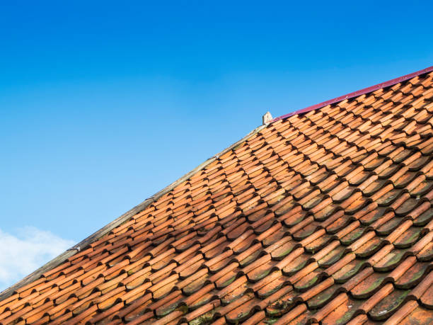 istock Roof shingles against a blue sky 1405989491