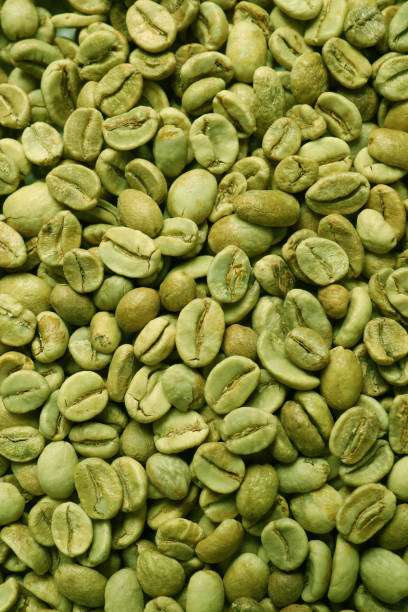 istock Many green coffee beans as background, top view 1405990055