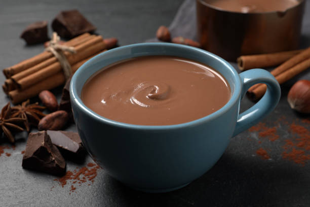 istock Yummy hot chocolate in cup on black table 1405991016