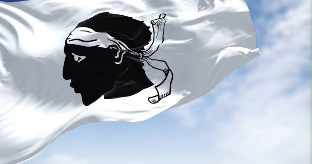 The flag of Corsica waving in the wind on a clear day The flag of Corsica waving in the wind on a clear day. The Corsica is an island of the Mediterranean Sea and French administrative region, corsican flag stock pictures, royalty-free photos & images