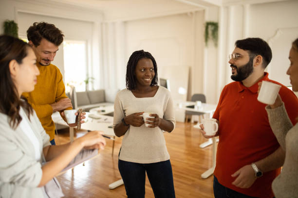 istock Multiracial female and male colleagues talking during coffee break 1405991275