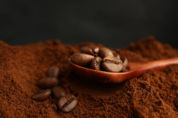 istock Coffee grounds and roasted beans on dark background, closeup 1405991521