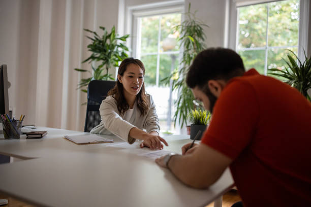 istock Candidate singing the job contract at the office 1405991522