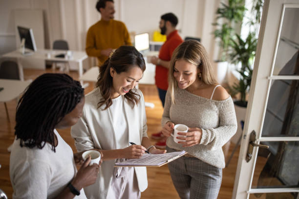istock Multiracial female colleagues talking at the office during coffee break 1405991934