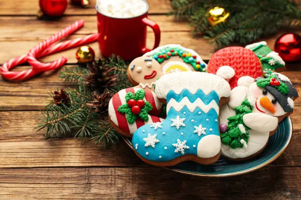 Delicious homemade Christmas cookies and festive decor on wooden table
