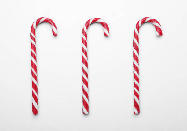 istock Many sweet Christmas candy canes on white background, flat lay 1405993124