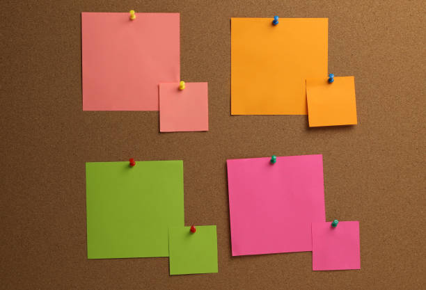 istock Colorful paper notes pinned to cork board 1405993784