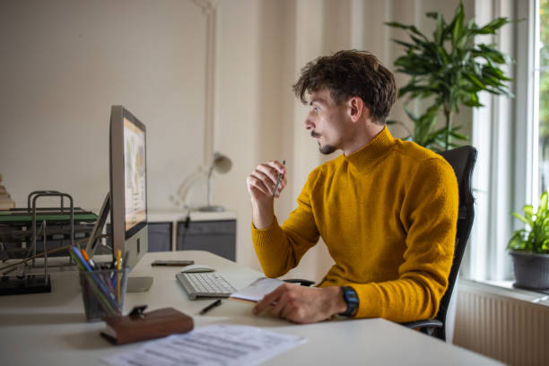 istock Caucasian man working at the modern office 1405994899