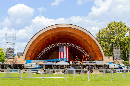 Boston, Massachusetts, USA - June 28, 2022: The Hatch Shell being prepared for hosting the Boston Pops Orchestra's annual Boston Fourth of July celebration. The Edward Hatch Memorial Shell (aka 