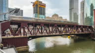 istock Time-lapse of train, car traffic transportation on railway bridge road, boat on river, and building construction in business district Chicago USA. American people city life, commuter transport concept 1405998086