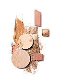 istock Casual make up products. Spills and smears of makeup foundation, eyeshadow, face powder and shimmering powder isolated on white background. Beauty, professional makeup, contouring, fashion concept. 1405998929