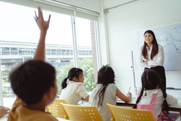 istock Student Raising Hand in Classroom Learning Bangkok, Thailand 1405998942