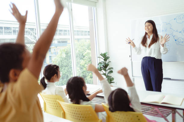 istock Student Raising Hand in Classroom Learning Bangkok, Thailand 1405998945