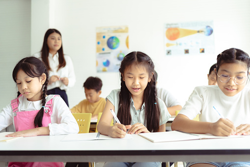 Students enjoying learning while in a Bangkok, Thailand Classroom.