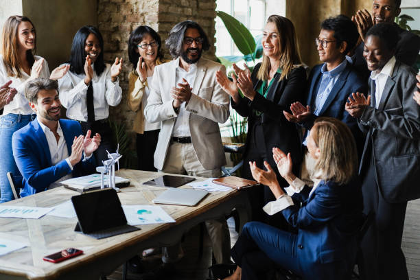 istock Multiracial business people celebrating together inside modern office - Focus on left man face 1405999180