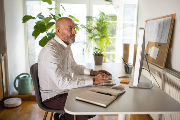 istock Mid-adult Caucasian man working on computer from his modern home office 1405999485