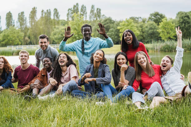 Multiethnic friends having fun at city park - Focus on indian girl face stock photo