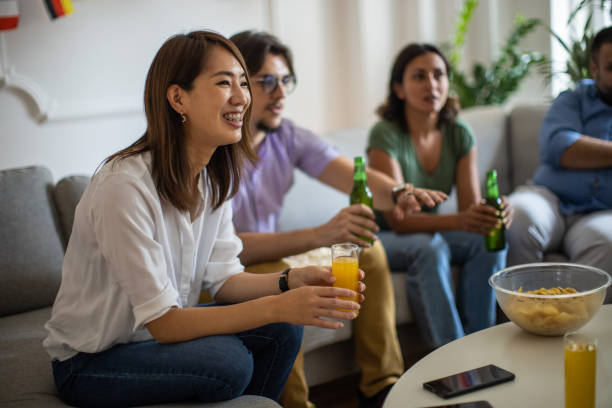 istock Multiracial friends watching a sport game on TV 1406002266