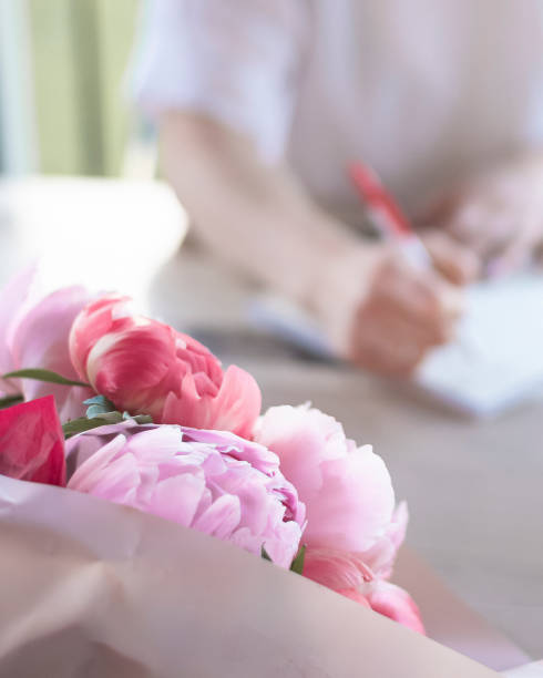 istock a young woman makes notes in a notebook, writes a list 1406002542