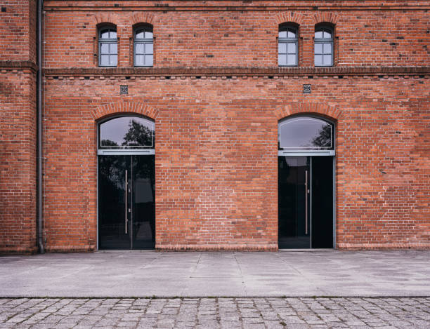 Old, empty industrial building Old, empty industrial building background with copy space store wall surrounding wall facade stock pictures, royalty-free photos & images