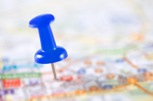 Blue push pin marking a location on a city map