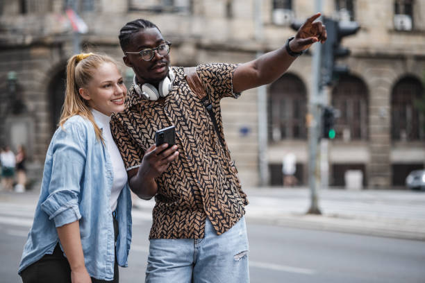 istock Shot of a young couple using gps on their mobile phone 1406005755