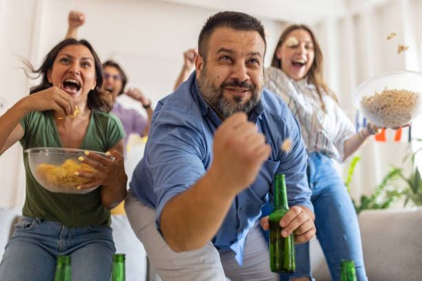 istock Excited multiracial friends cheering while watching a sport game on TV 1406006397