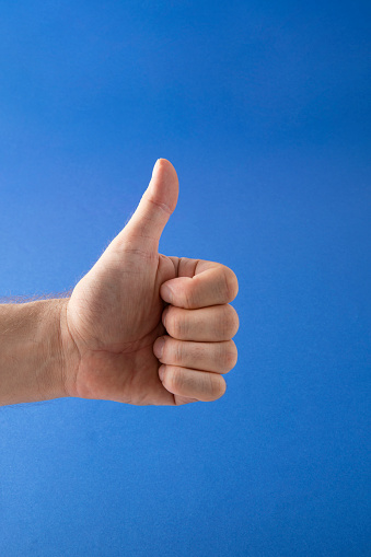 Thumb up on blue background