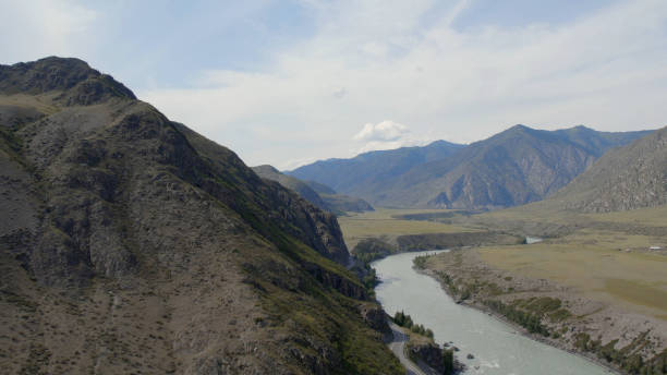 istock Fly between mountains and Katun river under blue sky in Altai 1406009276