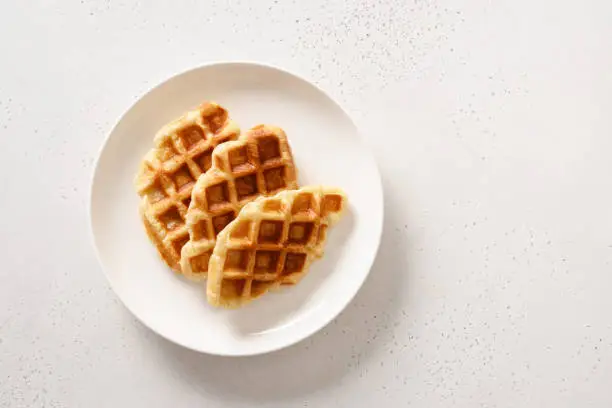 Photo of Trendy delicious breakfast with croffles on a white background. Croissant as waffle.