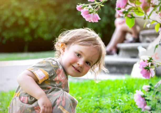 Little girl playing in the garden stock photo