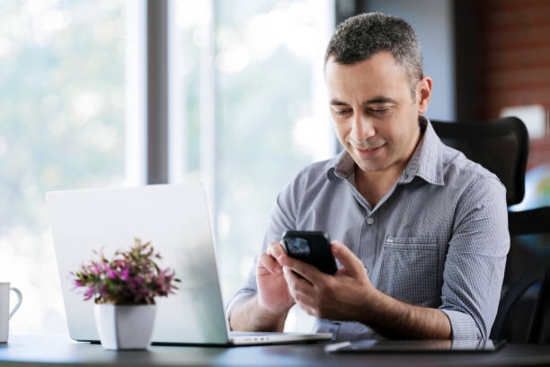 istock Portrait Of Man Working In The Office Or At Home Using Smartphone, Digital Tablet And Computer 1406013913