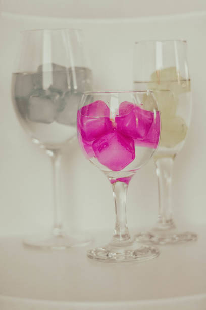 istock Pink ice cubes in the wine glass. 1406015471