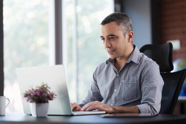 istock Portrait Of Man Working In The Office Or At Home Using Smartphone, Digital Tablet And Computer 1406015480