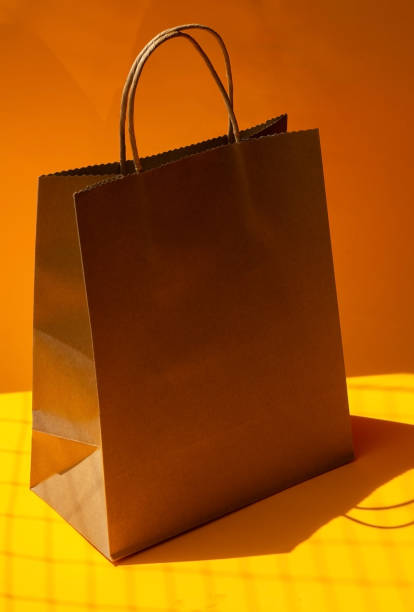 istock Vertical paper bag with orange background 1406016411