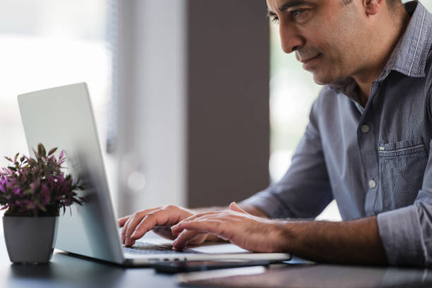 istock Portrait Of Man Working In The Office Or At Home Using Smartphone, Digital Tablet And Computer 1406018744
