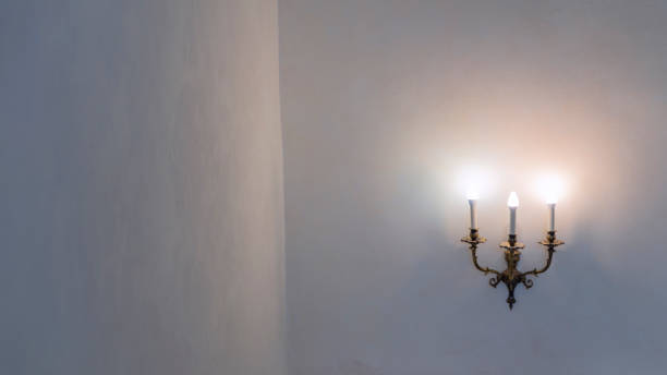 istock Vintage wall lamp. Space for text. Lamp light on the wall. Working lamps at dusk. 1406019937