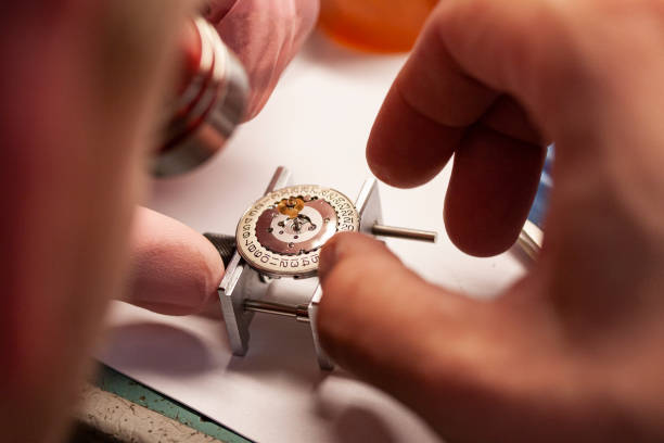 istock Watch repair at watchmaker with magnifying glass. 1406020330