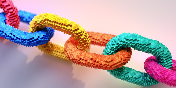 Conceptual blockchain image of a chain with individual links made from hundreds of small metallic blocks sitting on a plain background. With selective focus on the central part of the image.